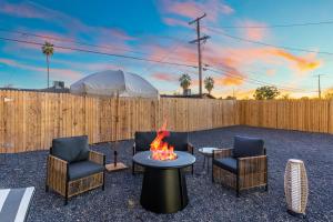 a backyard with a fire pit and chairs and a fence at Mesa Oasis - Pool - Game Room - Fire Pit in Mesa