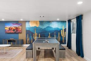 a ping pong table in a room with a mural at Mesa Oasis - Pool - Game Room - Fire Pit in Mesa