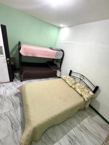 a small room with a bed and a pillow at Casa hotel Manhattan L&P in Choachí