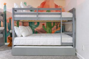 two bunk beds in a room with a mural at Mesa Oasis - Pool - Game Room - Fire Pit in Mesa