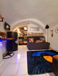 a living room with a couch and a table at Tiny studio, rustic style, historic center in Sanremo