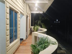 a balcony with benches and plants on a building at Bhanu Homestay in Nowgong