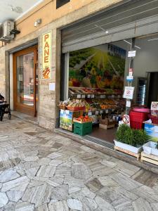 a store window with fruits and vegetables on display at Casa di WR in Imperia