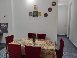 a dining room table with a vase of flowers on it at Bhanu Homestay in Nowgong