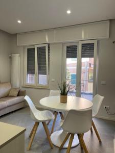 a living room with a table and chairs at Casa di WR in Imperia +21 photos