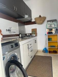 a kitchen with a washing machine in a kitchen at Moderne appartement in Larache +23 photos
