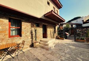 a brick building with a patio with a bench at The Pilgrim Ephesus Hotel in Selçuk