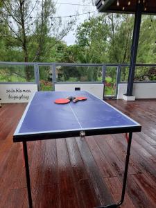 a ping pong table on top of a deck at Salablanca Brand New Jacuzzi Heated Pool PS5 VR Cinema Fully AC Indoors Smart TVs with Netflix Disney Plus Large Balcony in Tagaytay