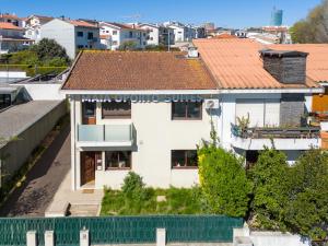 an aerial view of a white building with a red roof at Maia Oporto Suites in Maia