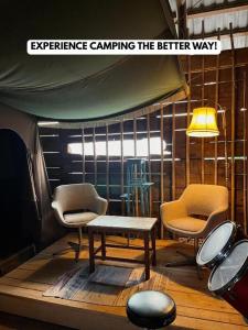 a room with two chairs and a table and a table and chairs at Nomads Village in Bled