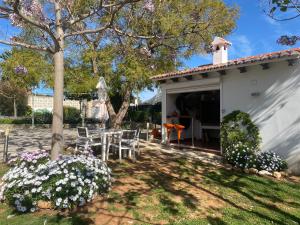 a house with a table and chairs in the yard at Berg & Zon Private & Pet frendly in Gandía