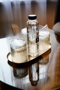 a glass jar and two containers on a table at Villa Royal in Craiova