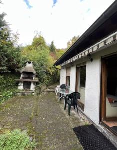 a patio with a table and a bench next to a house at Hotel Garni Silberdistel in Nenningen