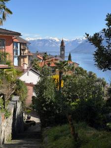 a small town with a clock tower on a hill at Molino Vecchio in Ronco sopra Ascona