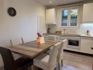 a kitchen with a wooden dining table and chairs at Molino Vecchio in Ronco sopra Ascona