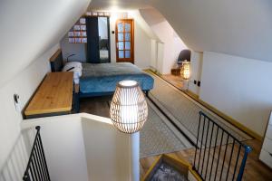 an attic room with a bed and a staircase at Villa Royal in Craiova