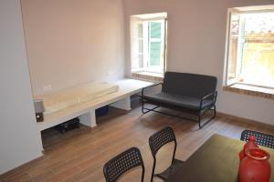 a living room with a bench and a chair at Lemonia apartment Old Town in Corfu