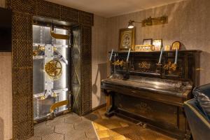 a room with a piano in the corner of a room at THE HIDDEN BANK: Silver Bullet in Plovdiv