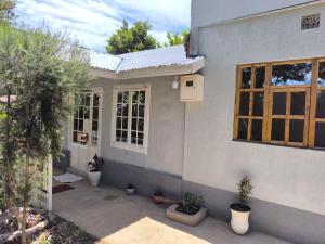 a house with potted plants sitting outside of it at Mizpah House in Kikuyu