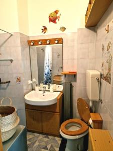 a bathroom with a sink and a toilet and a mirror at Bell-House in Varazze