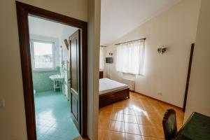 a small room with a bed and a bathroom at Gli olivi in Formello +11 photos