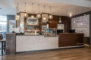 a bar in a restaurant with a counter at Premier Inn Koblenz City in Koblenz
