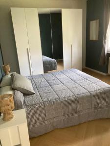 a bedroom with a large bed and a white cabinet at Casa Fenice in Romano D'Ezzelino