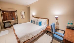 a bedroom with a bed and a desk and a chair at Indie Stays Studio Kharadi in Pune +33 photos