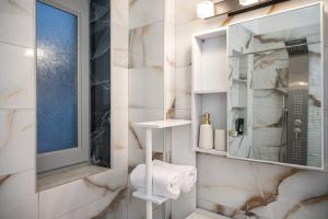 a bathroom with a sink and a mirror at Villa Leta in Kokkari +27 photos