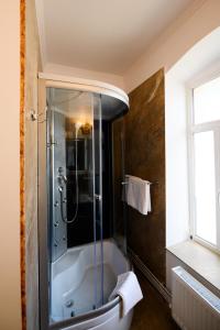 a bathroom with a shower and a bath tub at Villa Royal in Craiova +39 photos