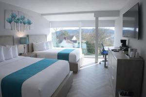 a hotel room with two beds and a large window at Athens Central Hotel in Athens +40 photos