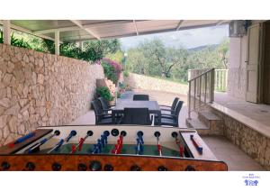 a table and chairs with a boat in a patio at B&B Corte degli Ulivi in Mattinata