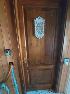 a wooden door with a sign on it at Flat in Chiesina Uzzanese in Chiesina Uzzanese