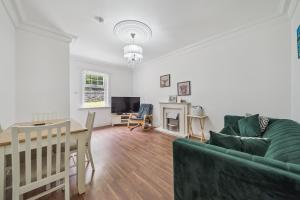 a living room with a couch and a table at Cottage on the Loch in Arrochar