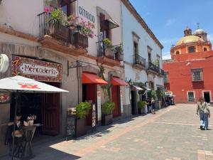 a street with buildings and a building with a dome at Centro 19 Hotel in Querétaro