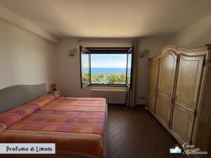 a bedroom with a bed and a large window at Casa Bellavista in Bergeggi