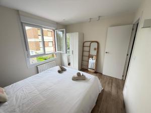 a bedroom with a white bed with towels on it at Lively Sopela House by Kima Gestíon in Sopelana