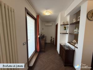 a hallway with a door to a room with a window at Casa Bellavista in Bergeggi +37 photos