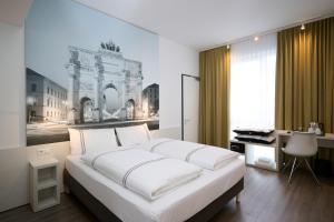 a bedroom with a large white bed and a desk at Premier Inn München City West in Munich