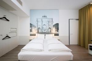 a row of beds in a room with a picture of a building at Premier Inn München City West in Munich