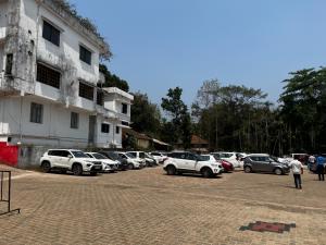 a group of cars parked in a parking lot at Rangoli Suites & Restrobar in Bantvāl