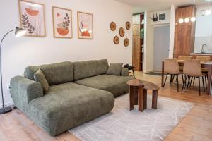 a living room with a couch and a table at Forestline Apartment Sinaia in Sinaia