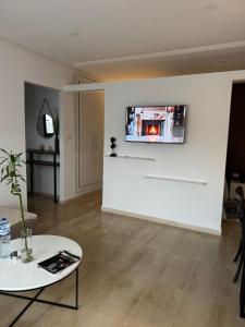 a living room with a tv on a wall at Le Chill Out in Tunis +9 photos