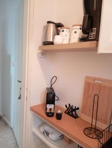 a kitchen with a wooden shelf with a coffee maker on it at Konstantinos in Chorto