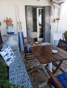a wooden table and chairs on a patio at Konstantinos in Chorto