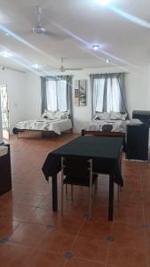 a room with a ping pong table and two beds at Casa Albino in Izamal