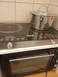 a pot on top of a stove in a kitchen at Konstantinos in Chorto +26 photos