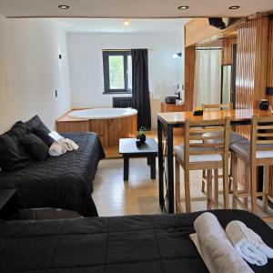 a living room with a bed and a dining room at Hotel Surprise Bariloche Centro con Desayuno y Restaurante in San Carlos de Bariloche