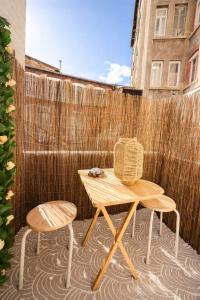 a wooden table and two chairs on a patio at MEEY Suite with Private Spa in Saint-Étienne