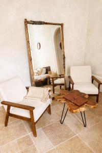 a living room with two chairs and a mirror at MEEY Suite with Private Spa in Saint-Étienne